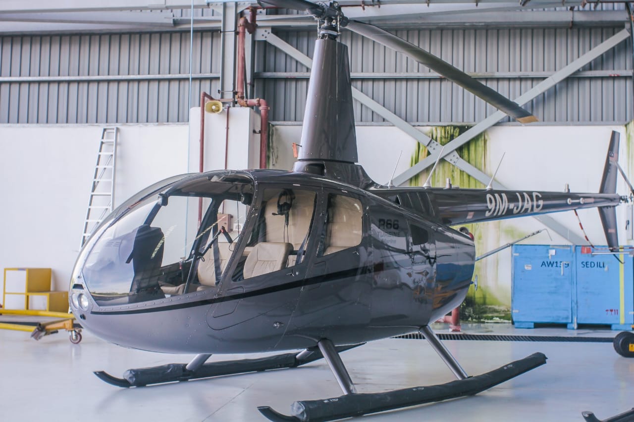 Robinson R66 helicopter side view inside a hangar